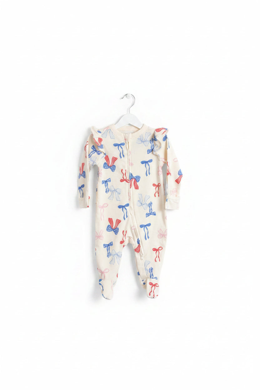 Red, white, and blue bow-print footed onesie