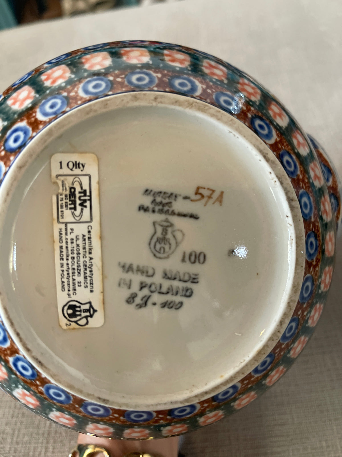 This is a Polish Pottery Unikat watering can pitcher in the "Dancing Blue Poppies" (U57A) pattern, measuring approximately 8.25 inches tall with a 71-ounce capacit