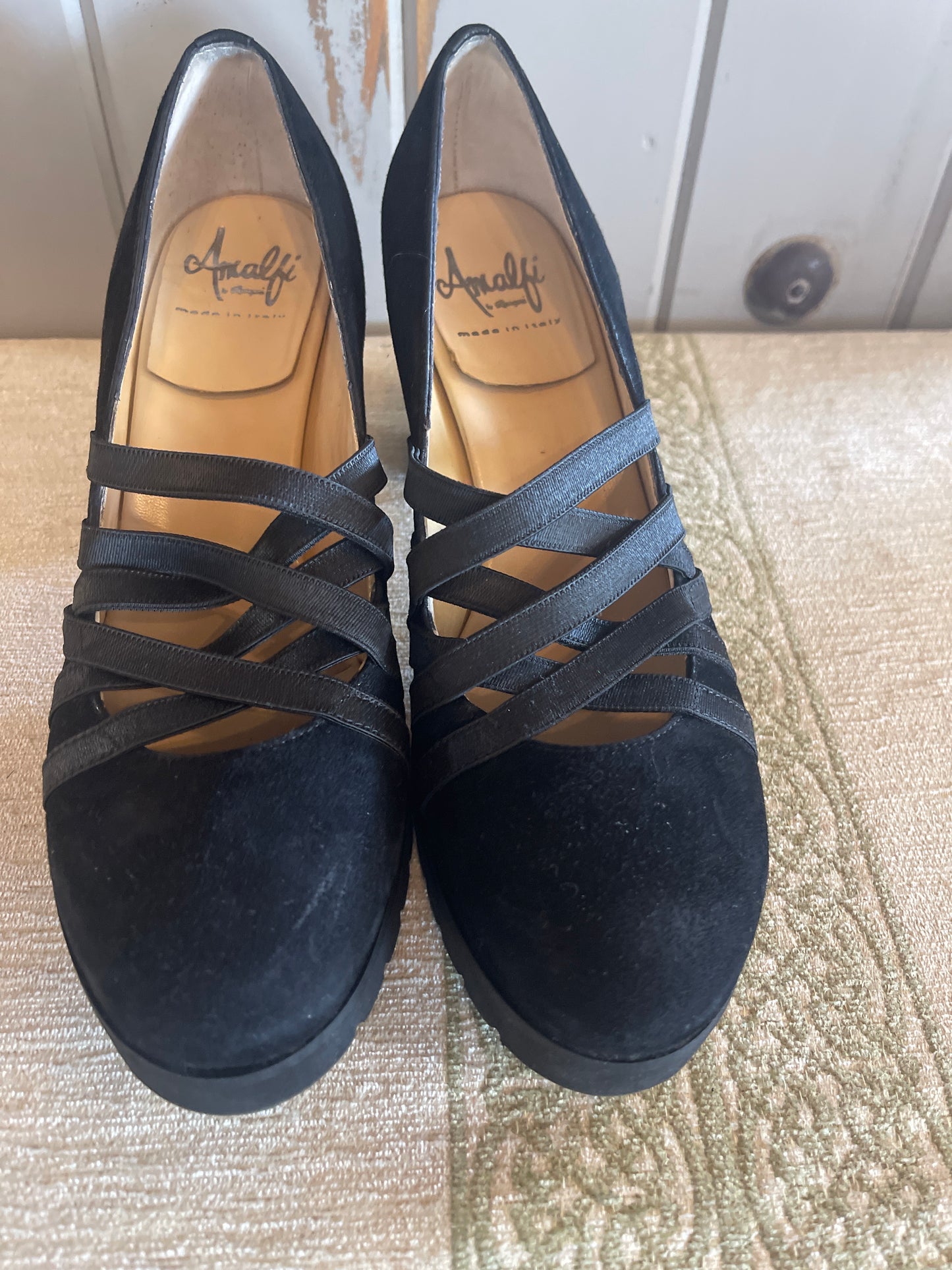 Amalfi black suede wedge shoes featuring crisscross strap detailing.