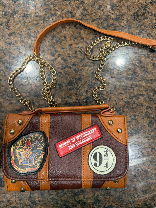Harry Potter "School of Witchcraft and Wizardry" trunk-style crossbody bag and wallet hybrid.