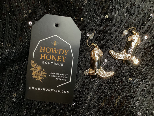 Cowboy boot earrings with rhinestones on a black sequined background, accompanied by a 'Howdy Honey Boutique' tag.