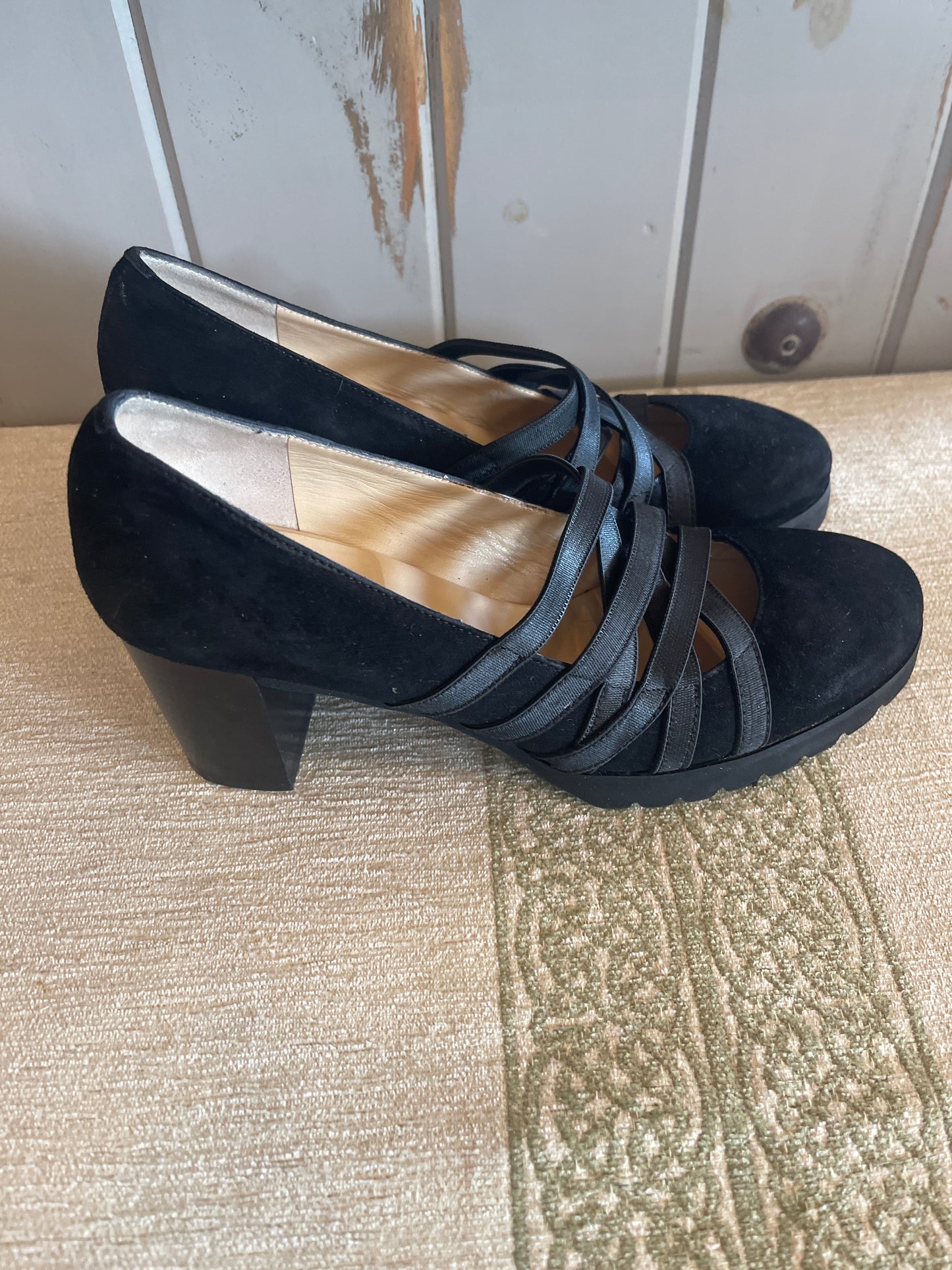 Amalfi black suede wedge shoes featuring crisscross strap detailing.