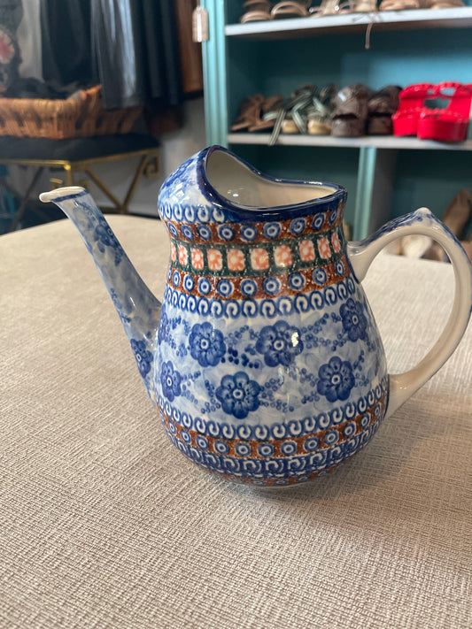 This is a Polish Pottery Unikat watering can pitcher in the "Dancing Blue Poppies" (U57A) pattern, measuring approximately 8.25 inches tall with a 71-ounce capacit