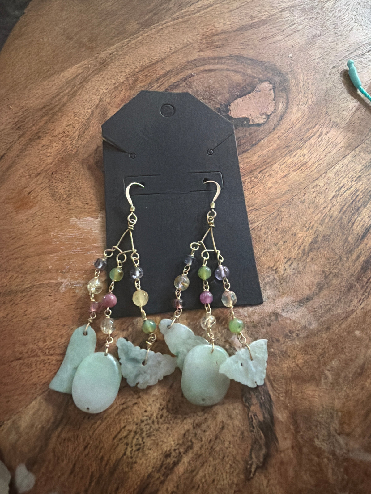 handmade wire-wrapped bohemian chandelier earrings made with multi-tonal gemstone beads and carved pale green jade drops