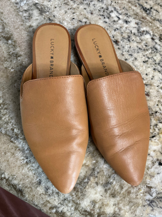 tan pointed-toe leather mules are by Lucky Brand.